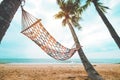 Landscape of hammock with coconut palm tree on tropical beach in summer. Royalty Free Stock Photo