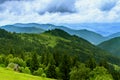 Landscape from height to mountain slopes, blue distance, meadow, house