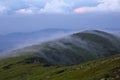 Landscape with high mountains. Amazing foggy summer morning. The early morning mist. A place to relax in the Carpathian Park,