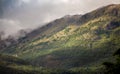 Landscape of high mountains grown with grass covered with clouds Royalty Free Stock Photo