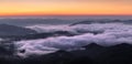 Landscape with high mountains. Panorama with amazing sunrise. Fields and meadow are covered with morning fog and dew. Touristic Royalty Free Stock Photo