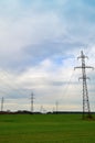 Landscape with high-voltage power lines. Electricity distribution station. Pylons in field Royalty Free Stock Photo