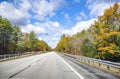 Landscape with a highway framed by autumn scenic maples in Massachusetts Royalty Free Stock Photo