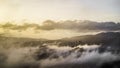 Landscape of hills with windmills on the covered in the fog under the sunlight in the evening Royalty Free Stock Photo