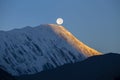 Landscape in Himalayas, Annapurna region, Nepal. Full moon during a sunrise on the background of snow-capped mountains Royalty Free Stock Photo