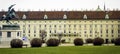 Landscape of Hofburg Imperial Palace building architecture with lots of windows and doors facade in pastel color with metal