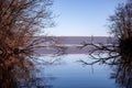 Landscape with a huge lake at the end of the autumn season. rocky mountains and high forests on the distant horizon. silhouettes o Royalty Free Stock Photo