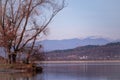 Landscape with a huge lake at the end of the autumn season. rocky mountains and high forests on the distant horizon. silhouettes o Royalty Free Stock Photo