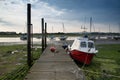 Landscape image of boats mored to jetty in harbor during Summer Royalty Free Stock Photo