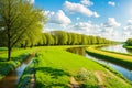 The canal goes through a sunny rural landscape in the spring.