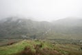 Moody landscape image of low cloud hanging over Snowdonia mountain range after heavy rainfall in Autumn with misty weather Royalty Free Stock Photo