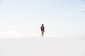 Man walking at White Sands National Monument in Alamogordo, New Mexico.