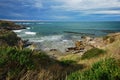 Landscape image of an oceanic beach with moody sky