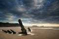 Landscape image of old shipwreck on beach at sunset in Summer