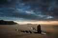 Landscape image of old shipwreck on beach at sunset in Summer