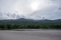 Landscape image of the road with lake , forest , mountain and blue sky Royalty Free Stock Photo