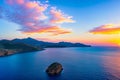 The sun is setting over the island of Crete, Greece.