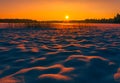 Landscape image of a sunset at winter with beautiful snow mounds Royalty Free Stock Photo