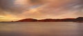 Landscape of lagoon mountains and sunset clouds over calm and serene polar arctic lake in Norway. Scenic view of barren