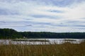 Landscape with lake, blue sky, clouds and trees. Beautiful nature landscape in a summer day Royalty Free Stock Photo