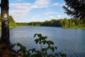 Landscape with lake, blue sky, clouds and trees. Beautiful nature landscape in a summer day Royalty Free Stock Photo