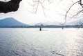 Landscape with the lake, boat, pagoda and mountains. Royalty Free Stock Photo