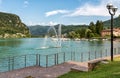 Landscape of Lake Ceresio with fountain in Lavena Ponte Tresa, Italy Royalty Free Stock Photo