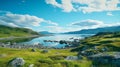 Landscape of a lake with a rocky shore on a bright cloudy day. Green hill with boulders by the seaside with a blue sky in Norway.