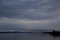 Landscape of a lake surrounded by hills under a cloudy sky in the evening - cool for backgrounds