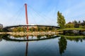 Landscape with the lake and suspended bridge from Drumul Taberei Park, also known as Moghioros Park, in Bucharest, Romania, at