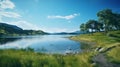 Landscape of a lake with trees near a field. Green hills by the seaside with a blue sky in Norway. A calm lagoon near a vibrant Royalty Free Stock Photo