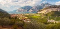 Landscape with lake, village, mountains, cliffs, meadows and olive trees. Lake Garda near Trombole, Riva del Garda. Royalty Free Stock Photo