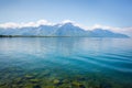 Landscape. Lakeside and snowy mountains at the sunny day