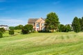 Landscape with a large country house. Large mowed lawn and blue sky