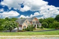 Landscape with a large country house. Large mowed lawn and blue sky