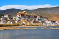 Landscape Little potala or shangri la tibetan monastery with lake in front of temple at shangrila old town , Zhongdian , Yunnan ,