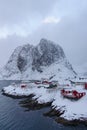 Landscape of the Lofoten Islands in Norway with traditional wooden red fisherman huts in front of the sea and this beautiful mouta Royalty Free Stock Photo