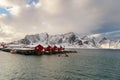 Landscape of the Lofoten Islands in Norway with traditional wooden red fisherman huts in front of the sea and this beautiful mouta Royalty Free Stock Photo