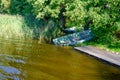 Landscape of a lonely lake shore and an overturned boat by the shore