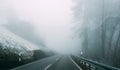 Misty remote road with slight snow