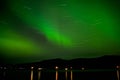 Landscape-long exposure of green Aurora Boreal en Kvaloya, Noruega in Norway Royalty Free Stock Photo