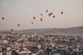 Landscape with a lot of hot air balloons in the sky over the city. Famous Turkish region Cappadocia with mountains and Royalty Free Stock Photo