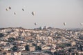 Landscape with a lot of hot air balloons in the sky over the city. Famous Turkish region Cappadocia with mountains and Royalty Free Stock Photo