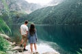 Landscape love. Couple man and woman together in summer park. Happy young romantic people at mountain lake landscape Royalty Free Stock Photo