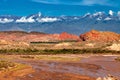 Landscape with a low-flow river with sandstone formations and mountains in the background