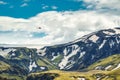 Landscape of lush rugged volcanic mountain with helicopter flying in Icelandic highlands on summer at Thorsmork