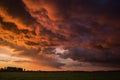 Landscape with majestic colorful dramatic red sky with fluffy clouds at sunset before before a thunderstorm and rain Royalty Free Stock Photo
