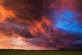 Landscape with majestic colorful dramatic red sky with fluffy clouds at sunset before before a thunderstorm and rain Royalty Free Stock Photo