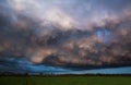 Landscape with majestic colorful dramatic red sky with fluffy clouds at sunset before before a thunderstorm and rain Royalty Free Stock Photo