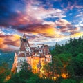 Landscape with medieval Bran castle known for the myth of Dracula at sunset Royalty Free Stock Photo